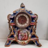 A FRENCH PORCELAIN MANTLE CLOCK, decorated with handpainted scene to the front with figures in a lan