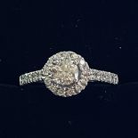 A FANTASTIC 18CT WHITE GOLD HALO DIAMOND RING, with a centre diamond that is framed with smaller dia