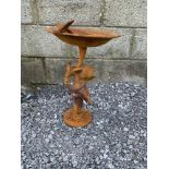 A GARDEN BIRD BATH, rusted look, with a single bird sitting upon the bath, the base in the form of a