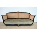 A LARGE REGENCY SETTEE, possibly Irish, with cane back, the frame ebonised with gilt highlight to th