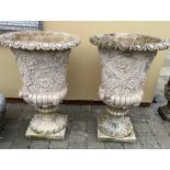 A PAIR OF STONE GARDEN URNS, with petal rim to the top, the body decorated with trailing floral desi