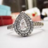 A BEAUTIFUL PEAR SHAPED DIAMOND ENGAGEMENT RING, with incredible sparkle, the diamond accented shoul