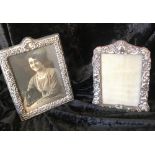 TWO SILVER SURROUND PHOTO FRAMES, One has repoussé decoration, image size 6” x 4”,velvet lined back,