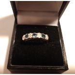 A 9CT WHITE GOLD DIAMOND AND TOPAZ STONE RING