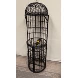 A WROUGHT IRON ‘BIRD CAGE’ WINE RACK / BAR holds bottles and glasses, ideal for long summer days in