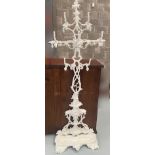 A FREESTANDING CAST IRON COAT STAND / TREE, painted white, with 7 hangers, and lift out drip tray be