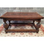 A JACOBIAN STYLE 19TH CENTURY EXTENDABLE DINING TABLE. Raised on baluster shaped carved legs, united