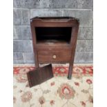 A GEORGIAN BEDSIDE/CHAIR SIDE CABINET, with three quarter gallery top having pierced side handles (b