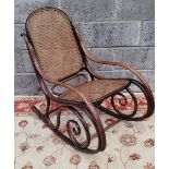 A VERY GOOD BENTWOOD ROCKING CHAIR, with cane back and seat, in very good condition commensurate wit