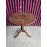 AN 18TH CENTURY TIP UP CENTRE TABLE, with oak top and fruit wood base, a column support on a tripod