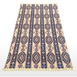 AN AZTEK CARPET, Design: blue geometric tribal repeat pattern on cream ground, Size: 300cm x 195cm a