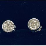 A PAIR OF 18CT WHITE GOLD RUB OVER DIAMOND STUD EARRINGS, with .75cts diamond.