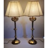 A PAIR OF GOOD QUALITY 19TH CENTURY GOTHIC STYLE POLISHED BRASS CANDLE STICK LAMPS, with silk shades