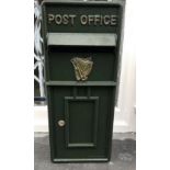 A GREEN POST BOX, with Irish harp decoration, 25 x 10 x 8 inches approx. (H x W x D).