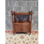 A TWO TIER MAHOGANY DUMB-WAITER / WHAT NOT, with fluted column supports, 2 door cabinet beneath, rai