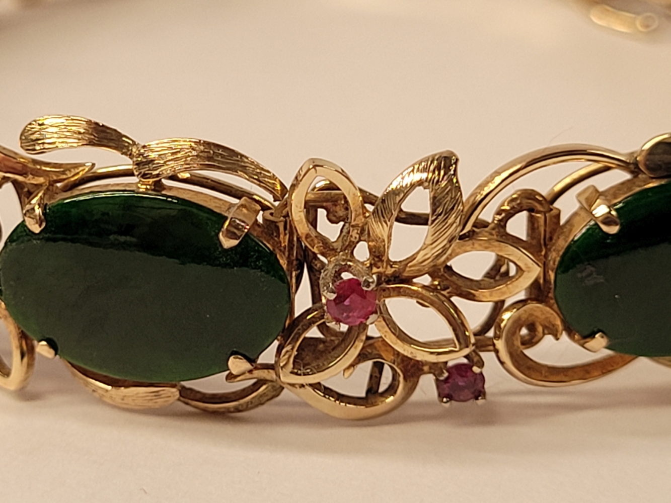 A 14CT YELLOW GOLD JADE AND RUBY BRACELET, 19cm long. Floral design setting. Marked 585 14K. - Image 2 of 7