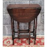 A LATE 19TH CENTURY OAK DROP LEAF OCCASSIONAL TABLE, with turned gate legs to front and back, 45.5 x