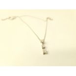 AN 18CT WHITE GOLD THREE DIAMOND PENDANT CHAIN, approx. .50ct of diamond total. Marked 750. Chain. 3