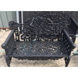 A PAIR OF BLACK COLOURED RAMS HEAD GARDEN BENCHES, with foliage design to the shaped back rest, and