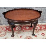 AN EARLY 19TH CENTURY TRAY ON ASSOCIATED BASE, the tray with scalloped rim and carved handles, the s