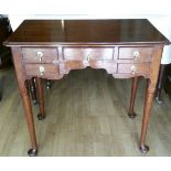 A GEORGE III MAHOGANY LOWBOY, with moulded top over a front shaped apron with five cock beaded drawe