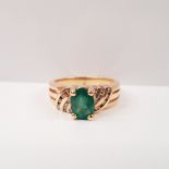 A 14CT YELLOW GOLD EMERALD AND DIAMOND RING, with oval central emerald stone, with diamond accented