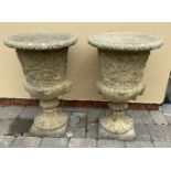 A PAIR OF GARDEN URNS, with floral design, 61cm tall approx.