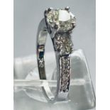 AN 18CT WHITE GOLD THREE STONE GRADUATED DIAMOND, with 2.20cts the ring is set off with shoulders ad