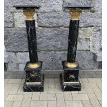 A PAIR OF BLACK MARBLE COLUMN JARDINERE STANDS, with decorative gilt brass colour metal trim, 4ft hi