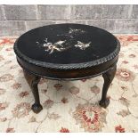 AN EARLY 20TH CENTURY EBONISED OCCASSIONAL TABLE, on claw and ball feet, 43cm high x 72cm wide appro