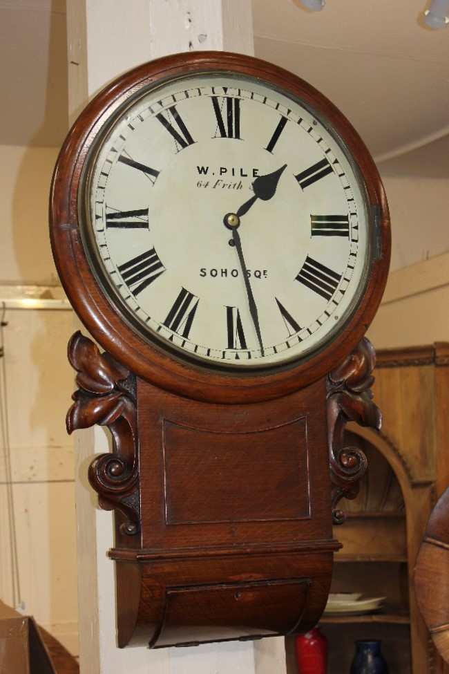 A mahogany drop dial circular wall clock, the 16 inch dial with Roman numerals and signed 'W. Pile