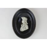 John Flaxman, a 19th century wax profile portrait on glass depicting Lord Nelson, signed, verso