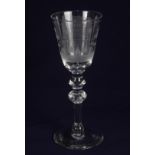 A 'Newcastle' type baluster wine glass, with Dutch engraving of a house and text: "Twelwesen Van