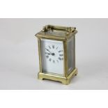 A brass and bevelled glass cased carriage clock, the dial with Roman numerals, with key, 11.5cm high
