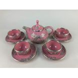 A Chinese pink pottery tea set, with overlaid pewter dragon chasing the flaming pearl design,