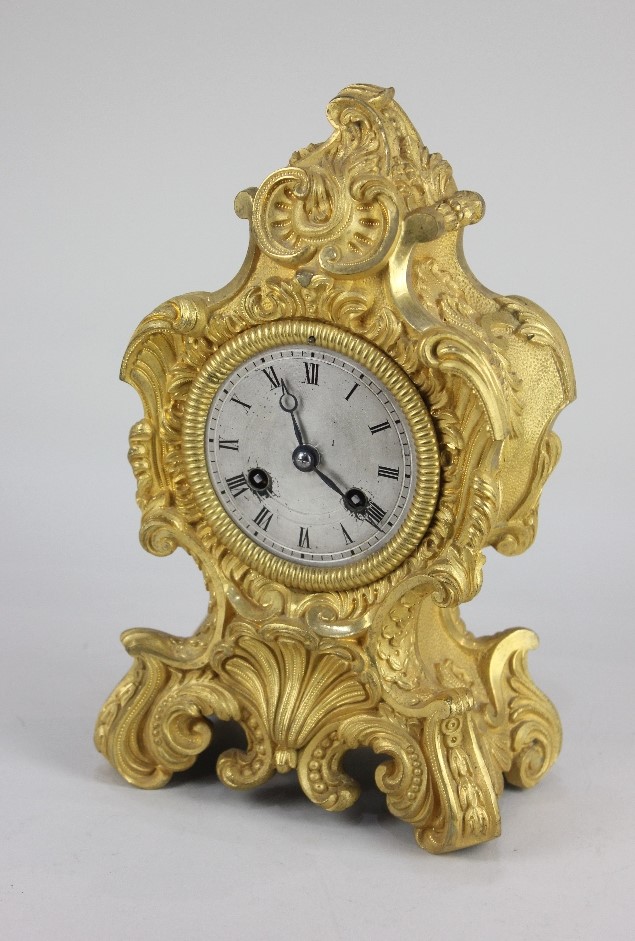 A 19th century French Rococo style gilt metal mantle clock, with eight day movement, the circular