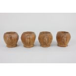 A set of four Robert Mouseman Thompson egg cups, octagonal form with carved mouse signature, 5cm