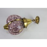 A brass and dimpled pink glass hanging ceiling light fitting, 35cm