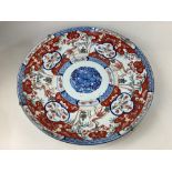 A Chinese porcelain charger, decorated with an Imari design of a bird and a tree, 45cm diameter