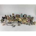 A collection of Chinese pottery figures and buildings, including a pagoda, temples and houses, men