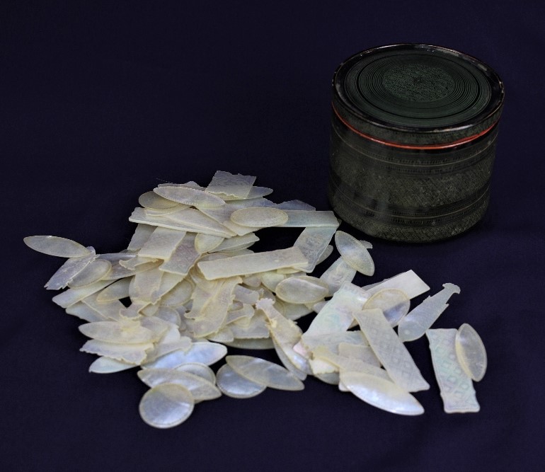 Approximately one hundred Chinese mother of pearl gaming tokens, various shapes and designs, in a