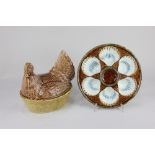 A 19th century French Longchamp majolica oyster dish 24cm and a Beswick chicken egg dish and