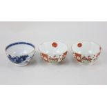 A pair of Japanese Kutani porcelain tea bowls, decorated with panels of blossom and flowers, marks