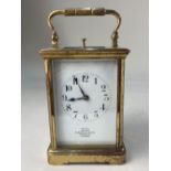 A gilt brass and bevelled glass cased repeater carriage clock, the white enamel dial with Arabic
