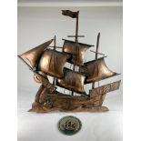 A copper wall plaque formed as a three-mast sailing ship, 76cm by 79cm, together with a metal