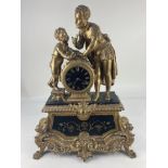 A 19th century gilt figural mantle clock, the circular black and gilt face, marked Philippe, the