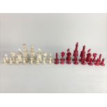 A 19th century bone and red stained carved ivory chess set, King 12cm high