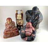 A collection of four ornamental Buddhas, various materials and poses, tallest 46cm high