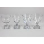 A collection of four glass rummers, to include one with decorative engraved border and tapered bowl,