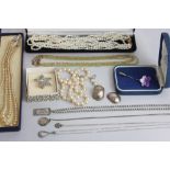 Four various silver chains; a pair of silver ear studs; a six row freshwater pearl necklace; two